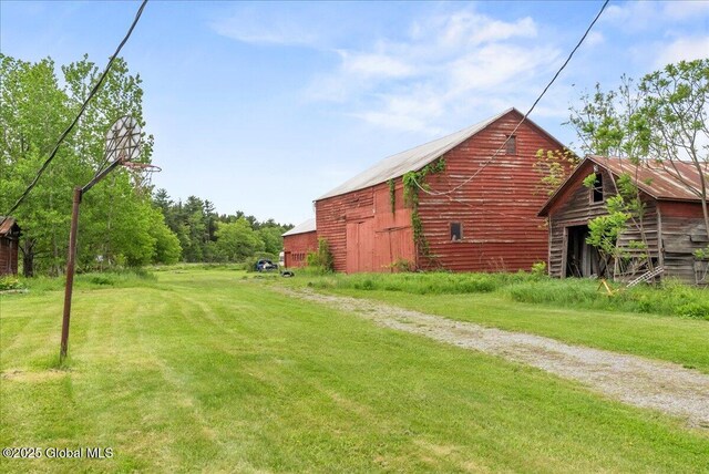 4248 Western Tpke, Guilderland, NY 12009 - view of grassy yard featuring a barn and an outbuilding