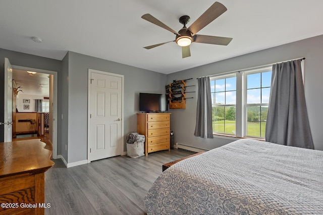 19 Lentine Way, Hebron, NY 12865 - bedroom featuring baseboard heating, wood finished floors, baseboards, and ceiling fan