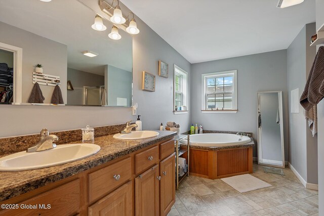 19 Lentine Way, Hebron, NY 12865 - full bath featuring a shower stall, a garden tub, double vanity, baseboards, and a walk in closet