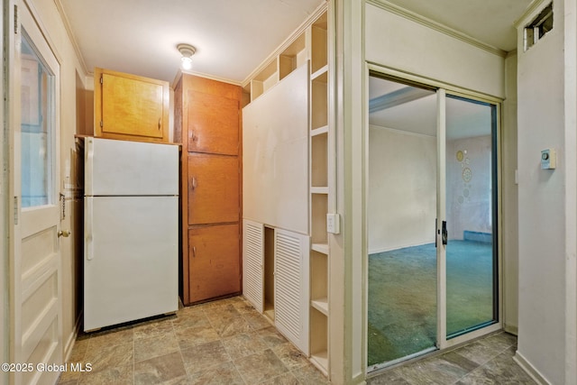 393 Whitehall Rd, Albany, NY 12208 - kitchen with freestanding refrigerator, crown molding, and light stone finish flooring
