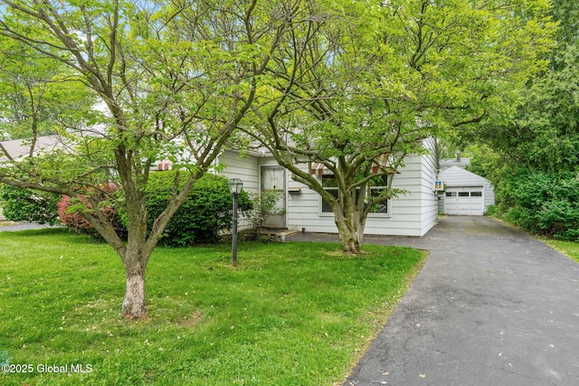 393 Whitehall Rd, Albany, NY 12208 - obstructed view of property with a front yard, an outdoor structure, a garage, and driveway