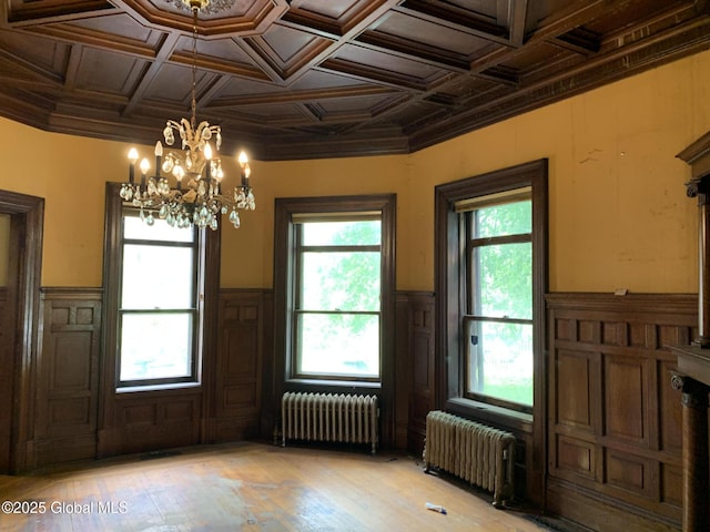 1077 University Pl, Schenectady, NY 12308 - unfurnished dining area with radiator, a chandelier, light wood-style floors, wainscoting, and coffered ceiling