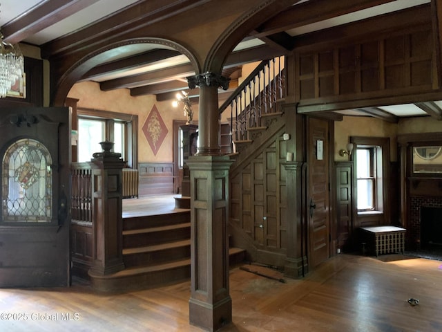 1077 University Pl, Schenectady, NY 12308 - entrance foyer featuring beam ceiling, wainscoting, wood finished floors, stairs, and arched walkways