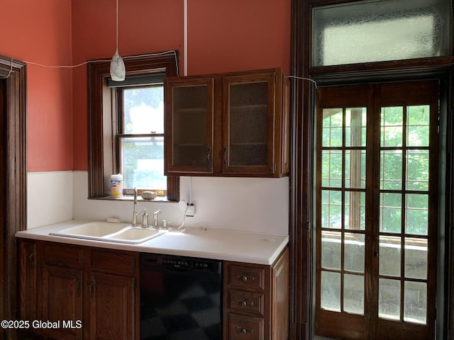 1077 University Pl, Schenectady, NY 12308 - kitchen with dishwasher, a sink, light countertops, glass insert cabinets, and pendant lighting
