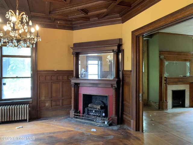 1077 University Pl, Schenectady, NY 12308 - unfurnished living room featuring a fireplace with flush hearth, radiator heating unit, ornamental molding, coffered ceiling, and a wainscoted wall