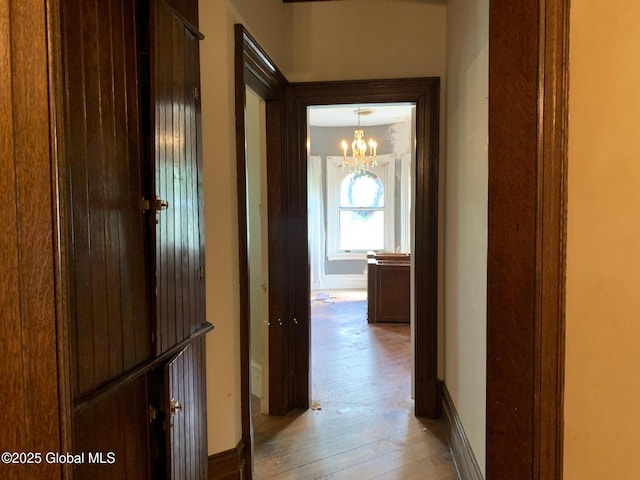 1077 University Pl, Schenectady, NY 12308 - hall featuring light wood-style floors, a chandelier, and baseboards