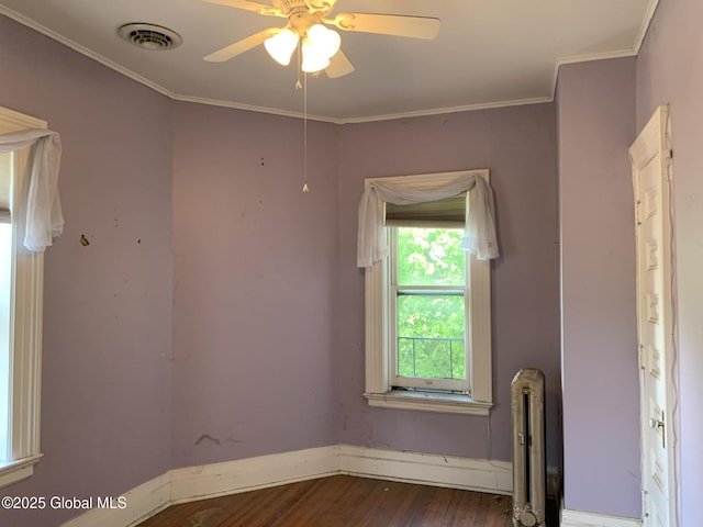 1077 University Pl, Schenectady, NY 12308 - empty room with dark wood-style floors, radiator heating unit, a ceiling fan, crown molding, and baseboards