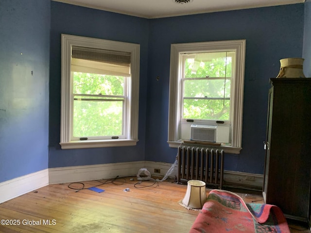 1077 University Pl, Schenectady, NY 12308 - unfurnished room featuring radiator, cooling unit, wood finished floors, and baseboards