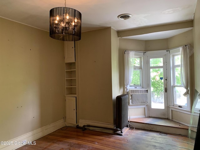 1077 University Pl, Schenectady, NY 12308 - unfurnished dining area featuring radiator, wood finished floors, a chandelier, and baseboards