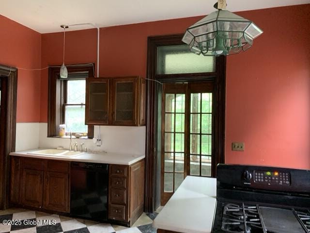 1077 University Pl, Schenectady, NY 12308 - kitchen with black appliances, a sink, a chandelier, and plenty of natural light