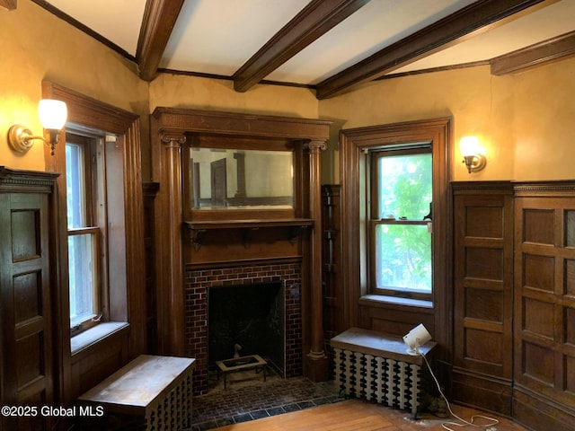 1077 University Pl, Schenectady, NY 12308 - living area with a tiled fireplace, beam ceiling, and wood finished floors