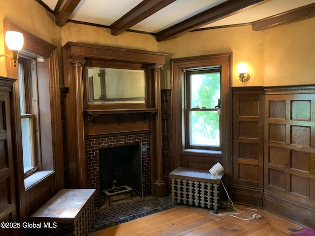 1077 University Pl, Schenectady, NY 12308 - living area with a tile fireplace, beamed ceiling, and wood finished floors