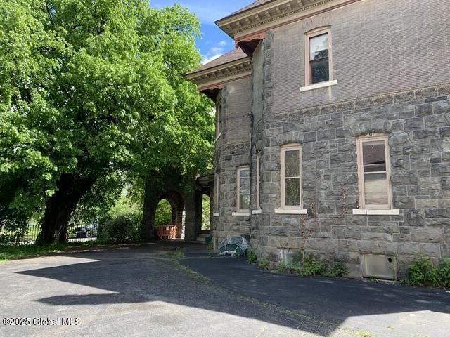 1077 University Pl, Schenectady, NY 12308 - view of side of home featuring stone siding