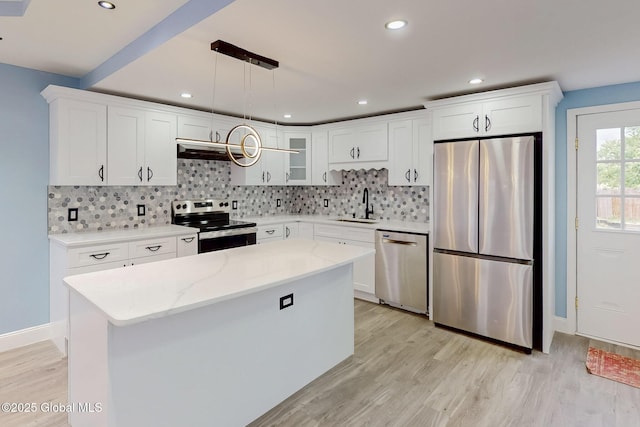 1813 Ave A, Schenectady, NY 12308 - kitchen featuring stainless steel appliances, a sink, under cabinet range hood, light wood finished floors, and backsplash