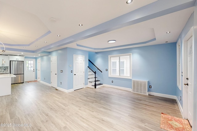 1813 Ave A, Schenectady, NY 12308 - unfurnished living room featuring a raised ceiling, stairs, baseboards, and recessed lighting