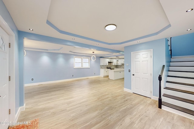 1813 Ave A, Schenectady, NY 12308 - unfurnished living room with a raised ceiling, light wood-style floors, stairs, baseboards, and recessed lighting