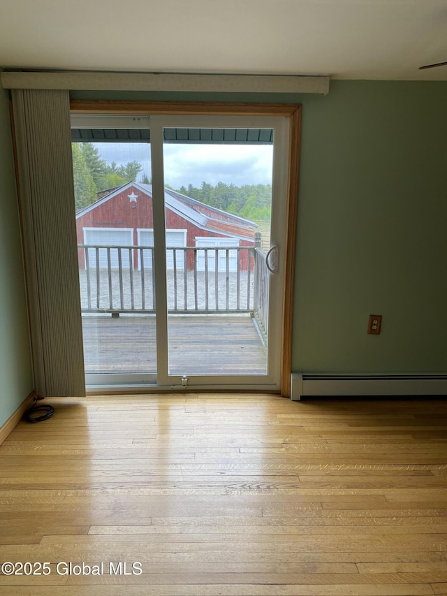 162 Garnet Lake Rd, Thurman, NY 12885 - spare room with a baseboard radiator and hardwood / wood-style flooring