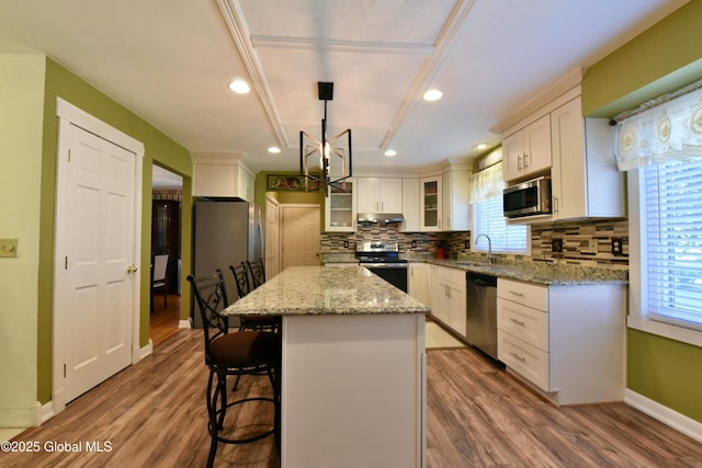 110 Old Coach Rd, Clifton Park, NY 12065 - kitchen featuring appliances with stainless steel finishes, plenty of natural light, tasteful backsplash, white cabinetry, and recessed lighting