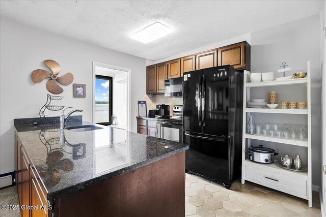527 Nys Route 9p, Stillwater, NY 12866 - kitchen featuring black appliances, a sink, dark stone countertops, a peninsula, and a textured ceiling