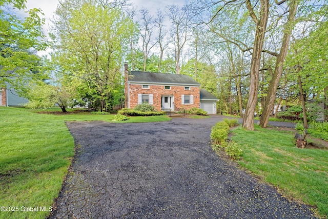 1832 Union St, Niskayuna, NY 12309 - view of front of home featuring brick siding, a front yard, asphalt driveway, and a garage