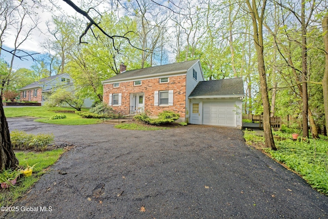 1832 Union St, Niskayuna, NY 12309 - colonial inspired home with a garage, driveway, a chimney, and brick siding