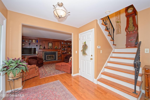 1832 Union St, Niskayuna, NY 12309 - entryway with wood finished floors, a fireplace with raised hearth, and stairs