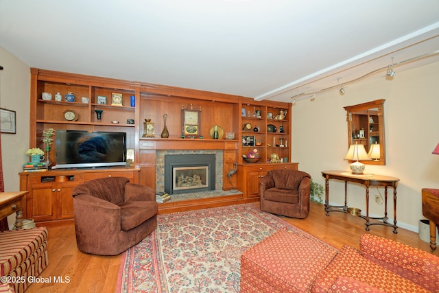 1832 Union St, Niskayuna, NY 12309 - living area with wood finished floors, a glass covered fireplace, and track lighting
