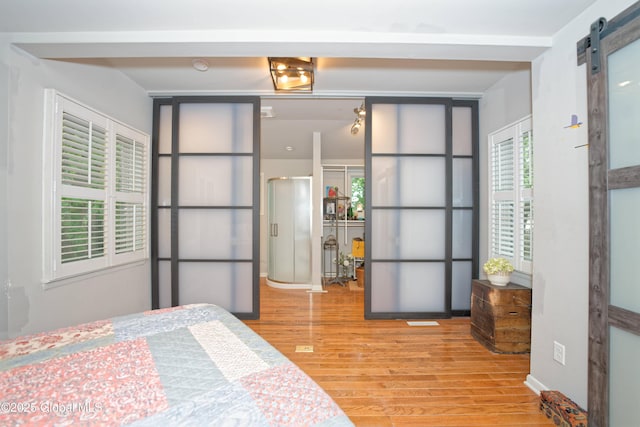 1832 Union St, Niskayuna, NY 12309 - bedroom featuring a barn door and wood finished floors