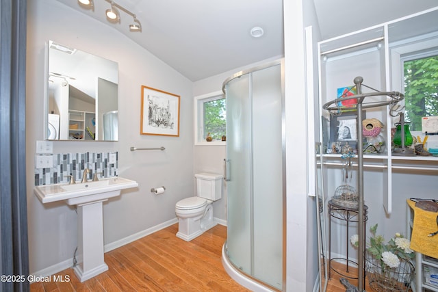 1832 Union St, Niskayuna, NY 12309 - bathroom with wood finished floors, vaulted ceiling, a shower stall, toilet, and baseboards