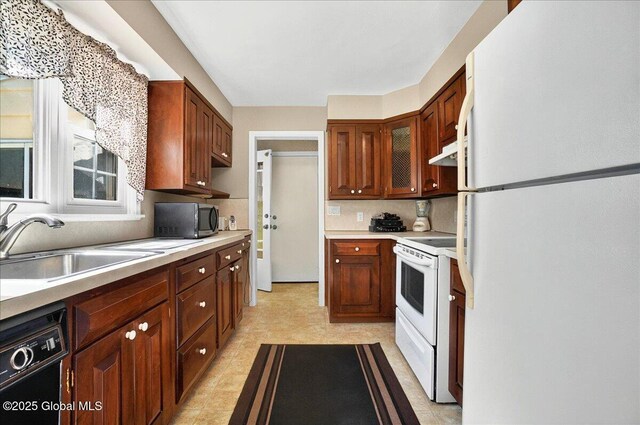 1324 Keyes Ave, Schenectady, NY 12309 - kitchen with black appliances, under cabinet range hood, light countertops, decorative backsplash, and light floors