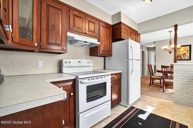 1324 Keyes Ave, Schenectady, NY 12309 - kitchen with white appliances, under cabinet range hood, a chandelier, light countertops, and brown cabinets