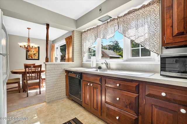 1324 Keyes Ave, Schenectady, NY 12309 - kitchen featuring black dishwasher, a chandelier, freestanding refrigerator, light countertops, and pendant lighting