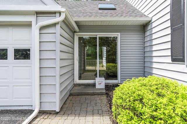 91 Gorman Rd, Menands, NY 12204 - view of exterior entry with a shingled roof and a garage