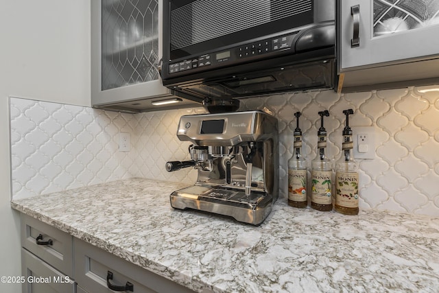 91 Gorman Rd, Menands, NY 12204 - kitchen with gray cabinetry, glass insert cabinets, decorative backsplash, and light stone counters