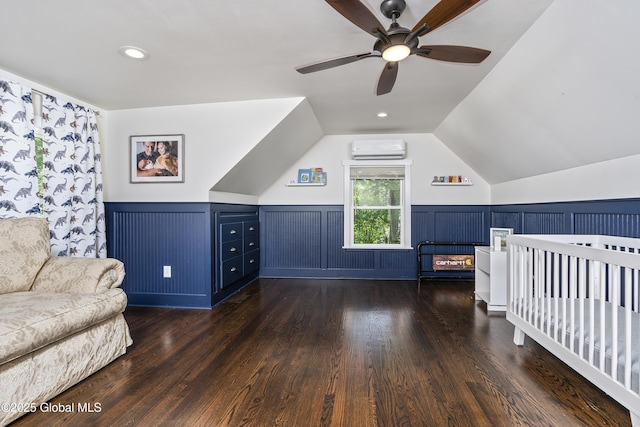 91 Gorman Rd, Menands, NY 12204 - bedroom featuring a wall unit AC, wainscoting, lofted ceiling, wood finished floors, and a ceiling fan