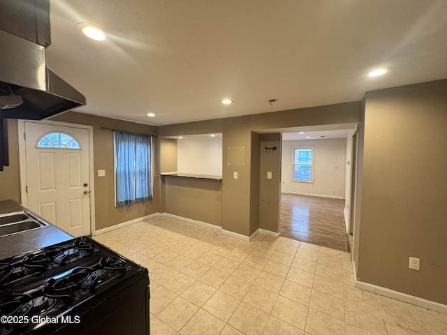 54 Sargent St, Cohoes, NY 12047 - kitchen with gas stove, wall chimney range hood, light tile patterned floors, recessed lighting, and baseboards