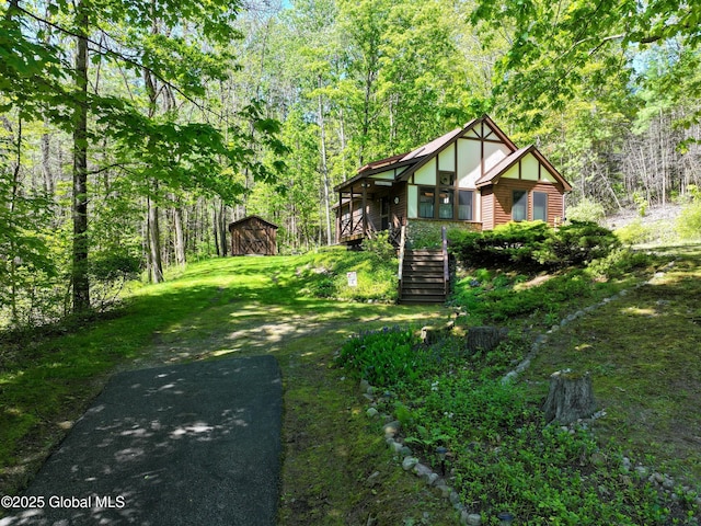 268 Dodd Hill Rd, Hague, NY 12836 - view of front of home with stairway, a wooded view, an outbuilding, and a front yard