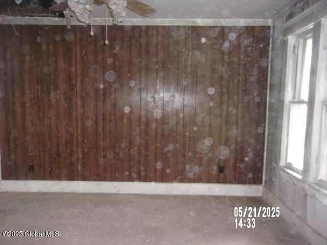 1745 Becker St, Schenectady, NY 12304 - spare room with healthy amount of natural light, ceiling fan, and wood walls