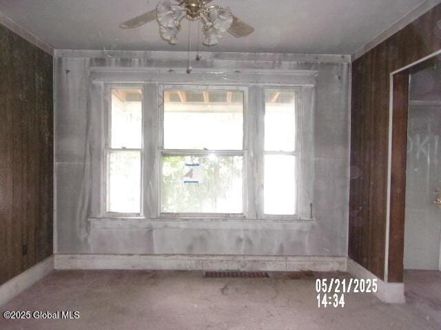 1745 Becker St, Schenectady, NY 12304 - unfurnished room featuring ceiling fan, plenty of natural light, and wooden walls