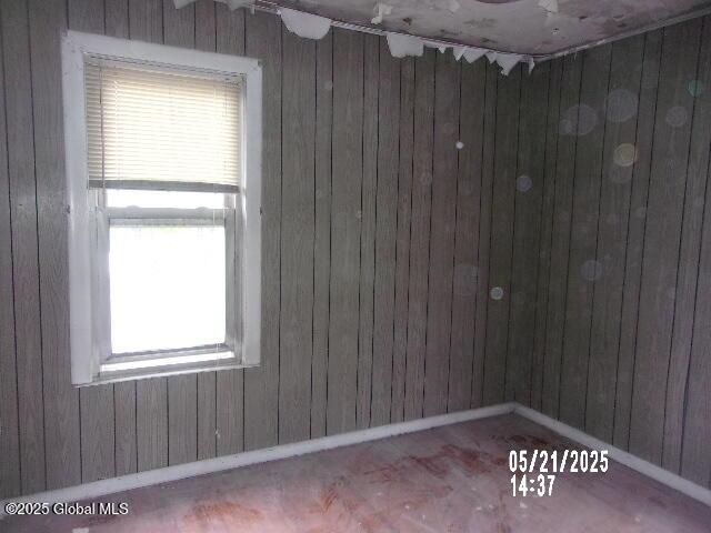 1745 Becker St, Schenectady, NY 12304 - spare room featuring plenty of natural light, wood walls, and baseboards