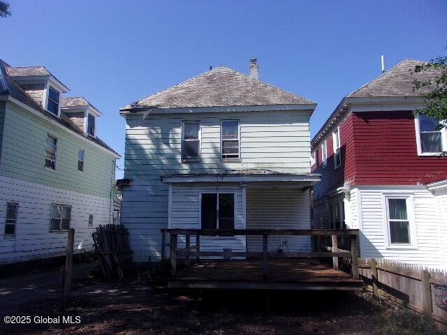 1745 Becker St, Schenectady, NY 12304 - back of house featuring a wooden deck and a chimney