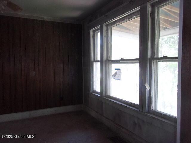1745 Becker St, Schenectady, NY 12304 - spare room with plenty of natural light and wood walls