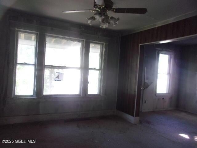 1745 Becker St, Schenectady, NY 12304 - unfurnished room featuring ceiling fan and wooden walls