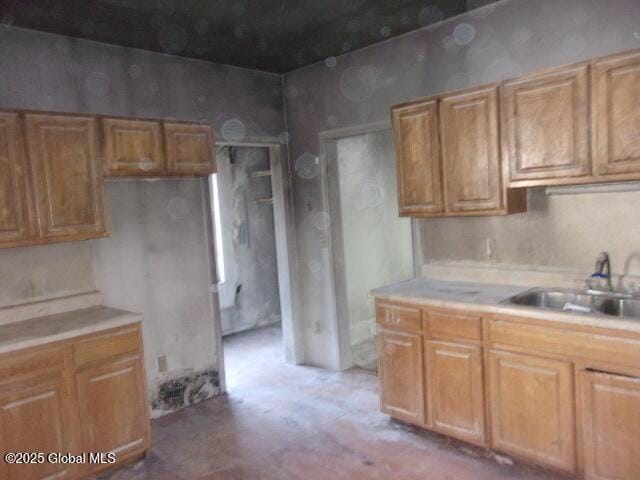 1745 Becker St, Schenectady, NY 12304 - kitchen with a sink, light countertops, concrete flooring, and brown cabinets