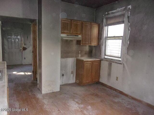 1745 Becker St, Schenectady, NY 12304 - kitchen with under cabinet range hood, brown cabinets, and light countertops