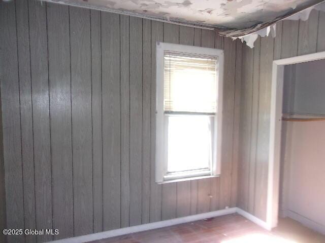 1745 Becker St, Schenectady, NY 12304 - unfurnished bedroom featuring wooden walls and baseboards