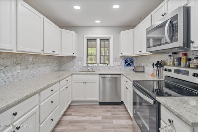 1920 Dover Rd, Niskayuna, NY 12309 - kitchen featuring stainless steel appliances, a sink, light wood-style flooring, backsplash, and recessed lighting