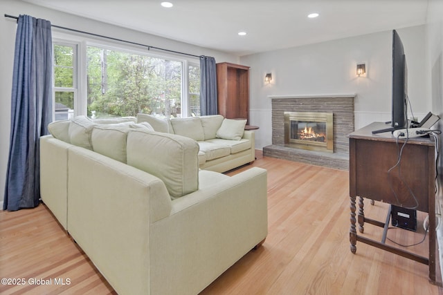 1920 Dover Rd, Niskayuna, NY 12309 - living room with light wood-style floors, a glass covered fireplace, and recessed lighting