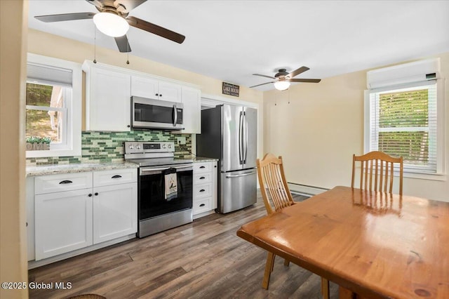 113 New Vermont Rd, Bolton, NY 12814 - kitchen with appliances with stainless steel finishes, a ceiling fan, tasteful backsplash, white cabinetry, and dark wood-type flooring