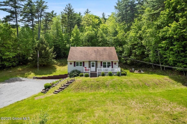 113 New Vermont Rd, Bolton, NY 12814 - view of front of home with a front lawn, a forest view, and covered porch